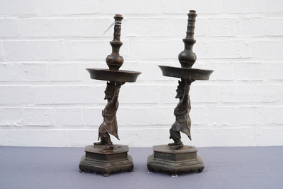 A pair of Chinese bronze candlesticks, Ming