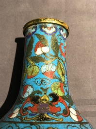 A Chinese cloisonn&eacute; bottle vase and a gilt bronze group, 18/19th C.