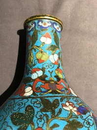 A Chinese cloisonn&eacute; bottle vase and a gilt bronze group, 18/19th C.