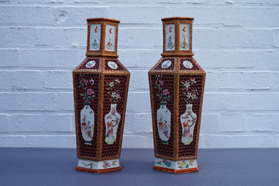 A pair of Chinese reticulated double-walled hexagonal famille rose vases, Yongzheng