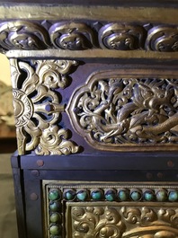 A turquoise-inlaid gilt bronze and copper repouss&eacute; 'tepchog' folding altar table, Tibet, 19th C.