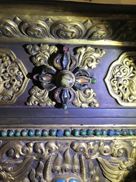 A turquoise-inlaid gilt bronze and copper repouss&eacute; 'tepchog' folding altar table, Tibet, 19th C.