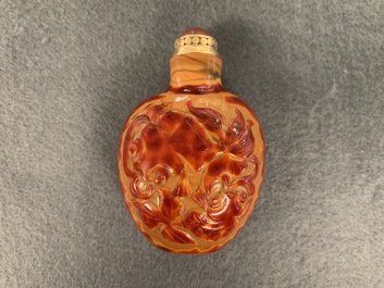 A Chinese carved realgar glass snuff bottle, Imperial Glassworks, Beijing, 1730-1840