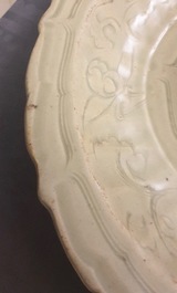 A Chinese Longquan celadon dish with incised floral design, early Ming