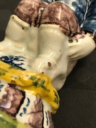 A rare polychrome Dutch Delft caster in the shape of a pooping man, 18th C.