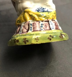 Une saupoudreuse en fa&iuml;ence de Delft polychrome en forme d'un homme chiant, 18&egrave;me