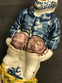 A rare polychrome Dutch Delft caster in the shape of a pooping man, 18th C.