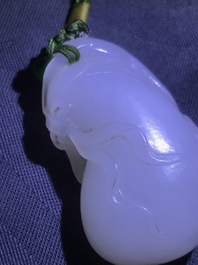 A Chinese white jade pendant of a monkey on a pouch, Qing