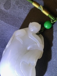 Un pendentif en jade blanc figurant un singe sur une pochette, Qing