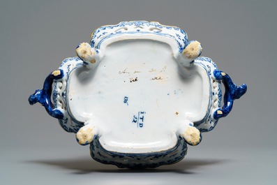 A reticulated Dutch Delft blue and white basket with a view on a wine cellar, 18th C.