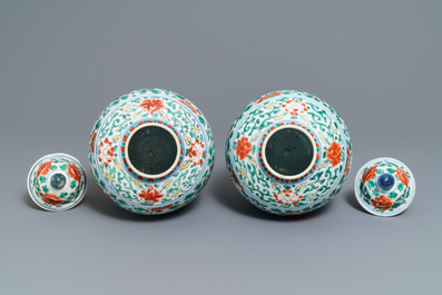 A pair of Chinese wucai vases and covers with boys among peonies, Transitional period