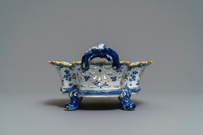 A reticulated Dutch Delft blue and white basket with a view on a wine cellar, 18th C.