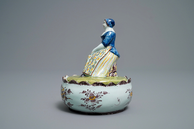 A polychrome Dutch Delft butter tub with a lady selling vegetables, 18th C.