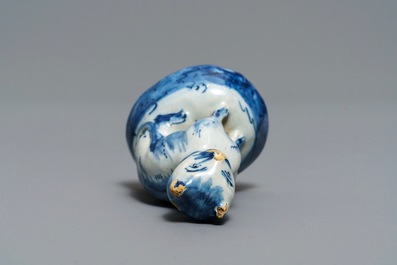 A Dutch Delft blue and white miniature model of a cat, 18th C.