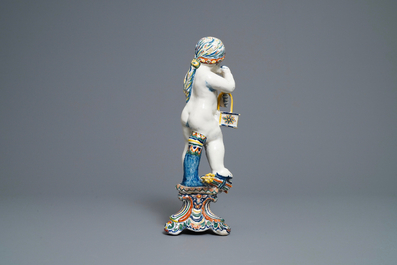 A polychrome Dutch Delft model of a boy, allegory of winter, 18th C.