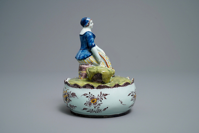 A polychrome Dutch Delft butter tub with a lady selling vegetables, 18th C.