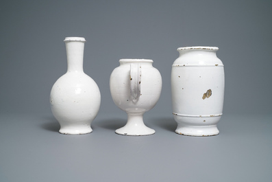 A large Dutch Delft blue and white albarello, a wet drug jar and a Brussels faience bottle, 18th C.