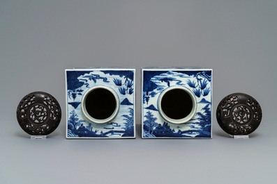 A pair of tall Chinese blue and white tea caddies with landscapes, 19th C.