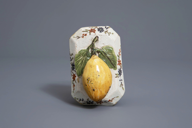 A polychrome Dutch Delft model of a lemon on a base, ca. 1800