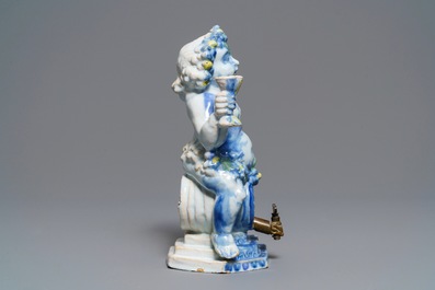 A polychrome Brussels faience 'Bacchus on a wine barrel' table fountain, 18th C.