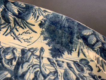 A very fine Dutch Delft blue and white dish with fighting horseriders, 18th C.