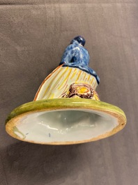 Un beurrier en fa&iuml;ence polychrome de Delft au couvercle en forme d'une marchande de l&eacute;gumes, 18&egrave;me