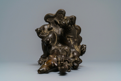 A large Chinese bronze group with Guanyin with child on a rock, Ming