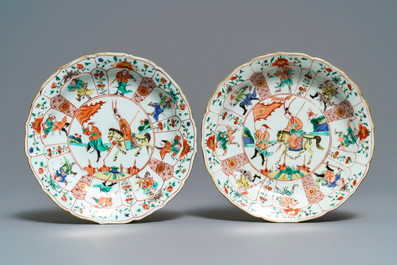 A pair of Chinese famille verte lotus-moulded 'Mu Guiying' plates, Kangxi