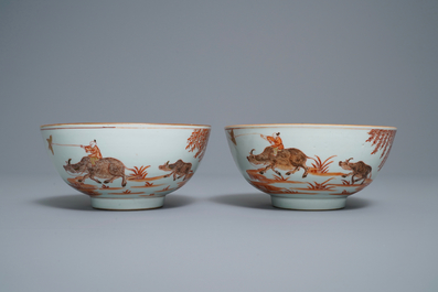 A pair of Chinese iron red bowls with a kiting boy on an ox, Yongzheng