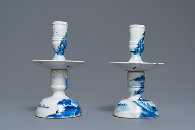 A pair of Chinese blue and white candlesticks and three famille rose figures of boys, 19th C.