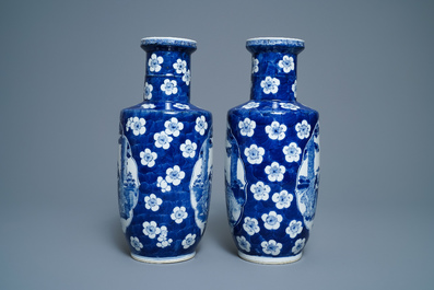 A pair of Chinese blue and white rouleau vases with figures near an elephant, Kangxi mark, 19th C.