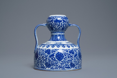 A Chinese blue and white two-handled 'lotus scroll' jug, Qianlong mark, 19/20th C.