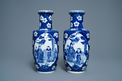 A pair of Chinese blue and white rouleau vases with figures near an elephant, Kangxi mark, 19th C.