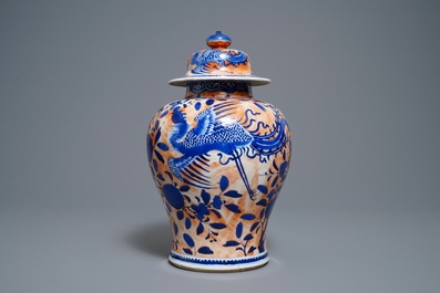 A Chinese blue and white clobbered 'qilin and phoenix' vase and cover, 19th C.