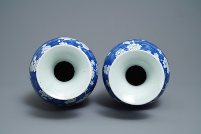 A pair of Chinese blue and white 'prunus on cracked ice' vases, 19th C.