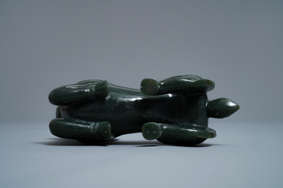 A Chinese spinach green jade model of a recumbent ram, 19/20th C.