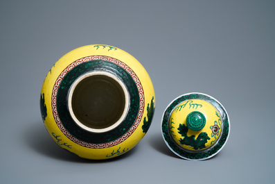 A Chinese yellow-ground famille verte vase and cover with Buddhist lions, 19th C.