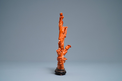 A Chinese carved red coral group of a lady and child, 19th C.