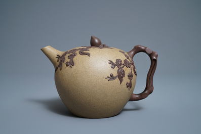 A large Chinese Yixing stoneware teapot with applied prunus design, Kangxi