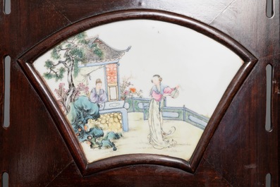 A Chinese wooden room divider with famille rose 'Romance of the Western Chamber' plaques, Republic