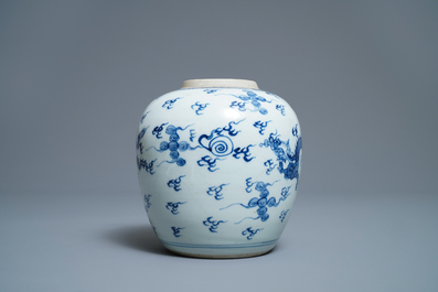 A Chinese blue and white 'dragon and phoenix' jar with wooden cover and stand, Kangxi
