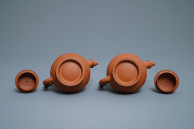 A pair of Chinese Yixing stoneware ewers with applied prunus design, Kangxi