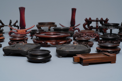 A collection of 33 Chinese carved wood stands, 19/20th C.