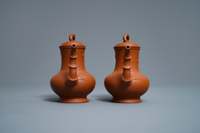 A pair of Chinese Yixing stoneware ewers with applied prunus design, Kangxi