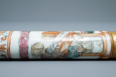 A Chinese famille rose opium pipe with silk pouch, 19th C.