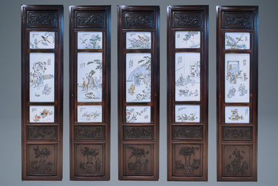 Une armoire en bois sculpt&eacute; orn&eacute;e de 23 plaques en porcelaine de Chine qianjiang cai, 19/20&egrave;me