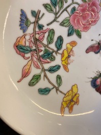 A Chinese famille rose 'ruby back' saucer dish with butterflies among flowers, Yongzheng