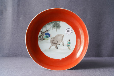 A Chinese famille verte coral-ground 'buffalo shepherd' plate, Yongzheng mark and of the period