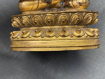 A Chinese coral- and turquoise-inlaid gilt bronze figure of Buddha Amitayus, 18/19th C.