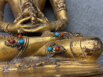 A Chinese coral- and turquoise-inlaid gilt bronze figure of Buddha Amitayus, 18/19th C.